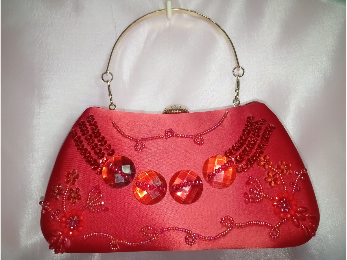Red embroidered party clutch with gold metal handle and crystal embellishments