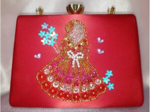 Red bridal clutch for hijabi bride with hand embellished gown design, pearl and bead detailing