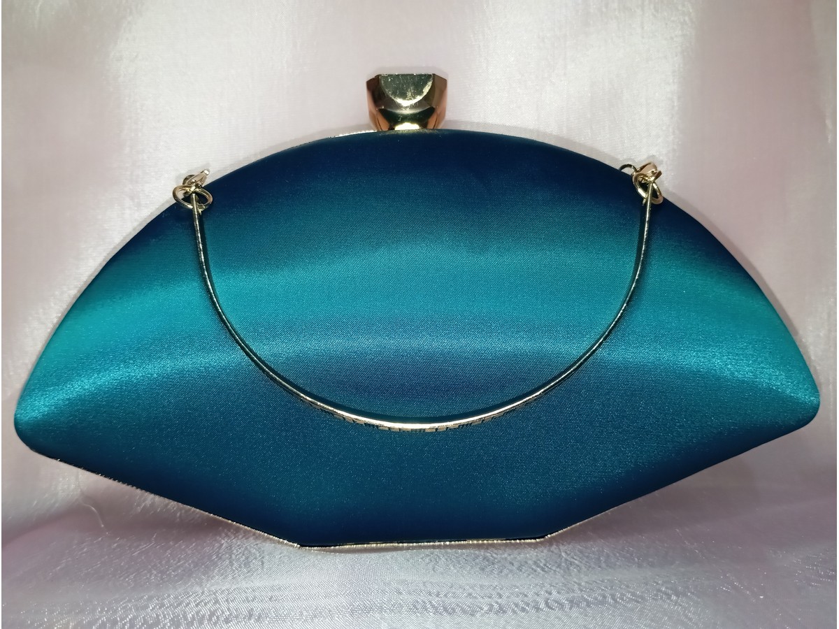 Back side of teal satin clutch with smooth finish and metal frame