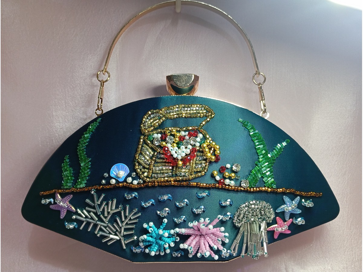 Teal embroidered party clutch with metal handle and ocean themed bead embellishments