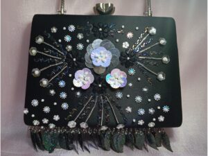 Black party clutch for women with floral embellishments, pearl details and sequin fringe