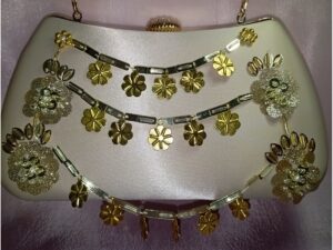 Beige fancy clutch for women with gold floral embroidery and hanging embellishments