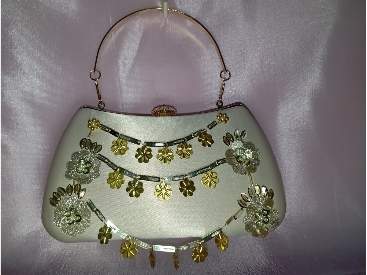 Beige embroidered clutch with gold handle and decorative floral design