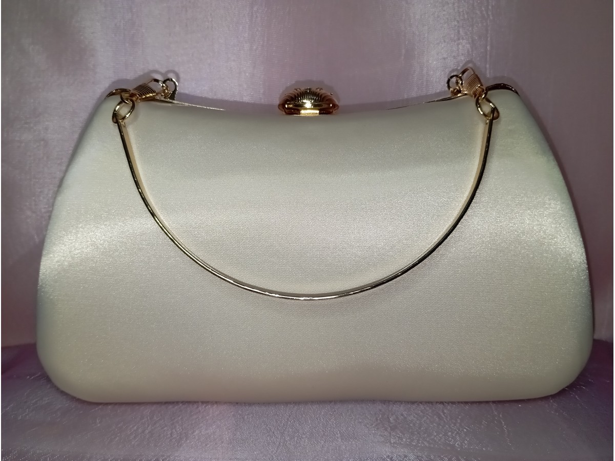 Back side of beige fancy clutch with smooth satin finish and gold frame
