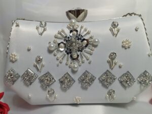 Close up of white pearl clutch for women with crystal floral embroidery and satin finish 01PW